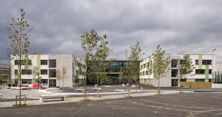 The three-storey school embraces a paved courtyard